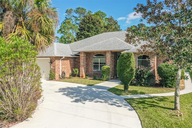 view of front of property with a front yard and a garage