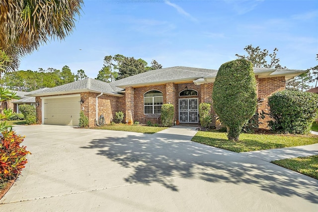 view of front facade with a garage and a front lawn