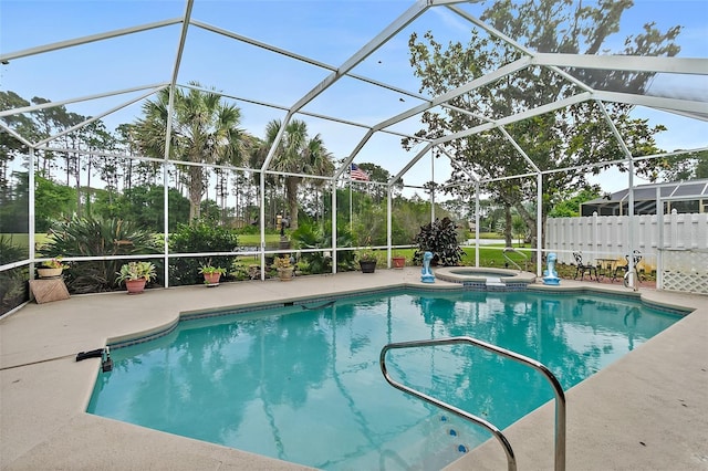 view of pool featuring glass enclosure and a patio area