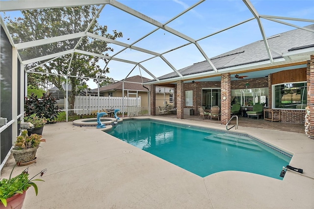 view of swimming pool featuring an in ground hot tub, a patio, glass enclosure, and ceiling fan