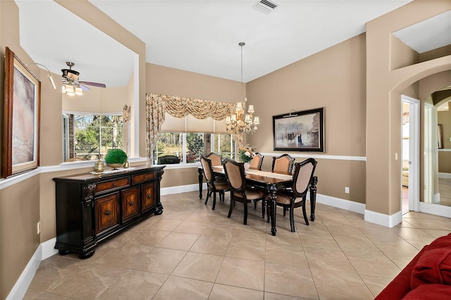 dining space featuring ceiling fan with notable chandelier and light tile patterned flooring