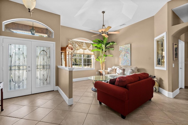 tiled foyer with ceiling fan and french doors