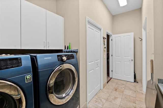 clothes washing area featuring cabinets and independent washer and dryer