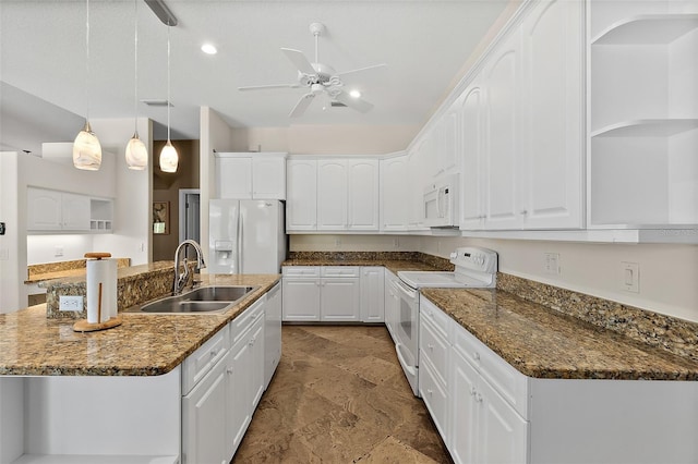 kitchen with sink, pendant lighting, white appliances, a kitchen island with sink, and white cabinets