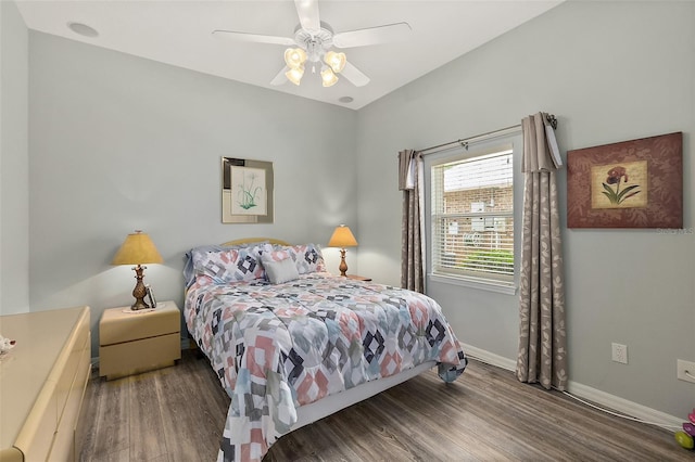 bedroom with ceiling fan and dark wood-type flooring