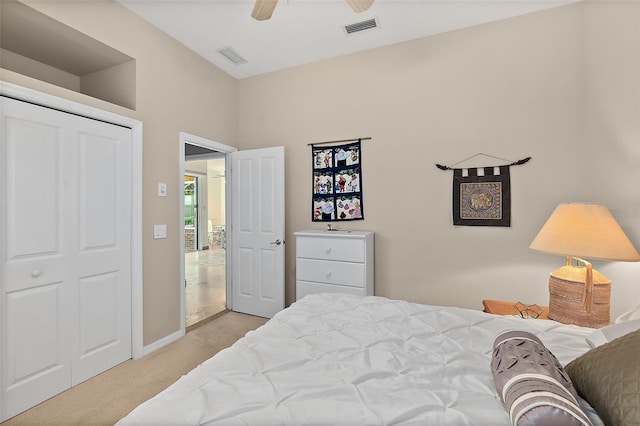 bedroom with ceiling fan, a closet, and light colored carpet