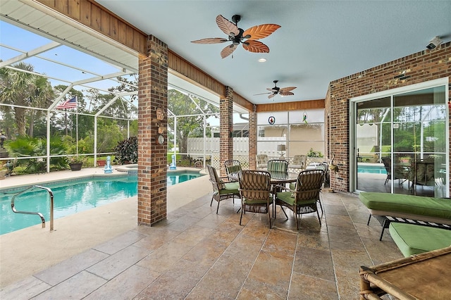 view of pool with a lanai, ceiling fan, and a patio area