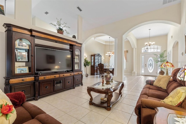 tiled living room with a chandelier and a towering ceiling