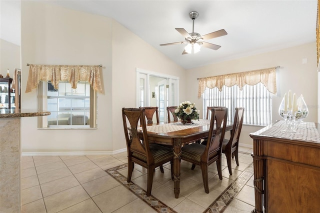 tiled dining area with ceiling fan and vaulted ceiling