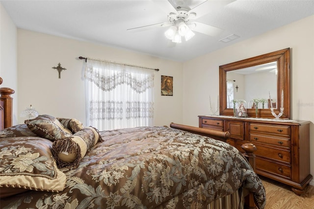 bedroom with ceiling fan and light hardwood / wood-style flooring