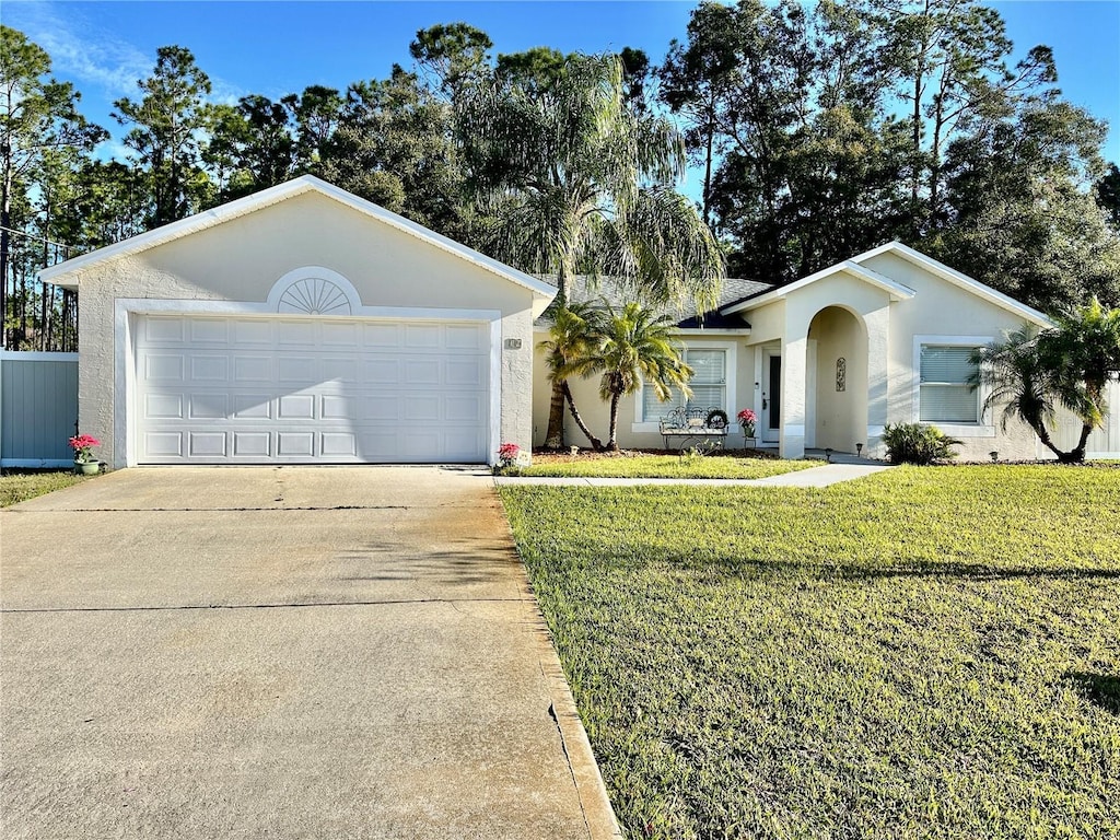 ranch-style house featuring a front lawn and a garage