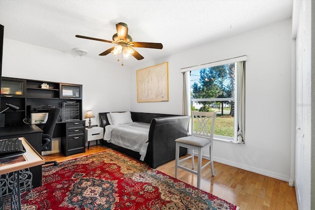 bedroom with light wood-type flooring and ceiling fan