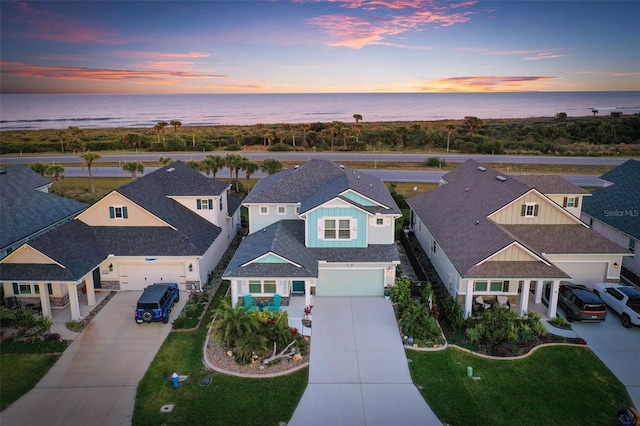 aerial view at dusk with a water view