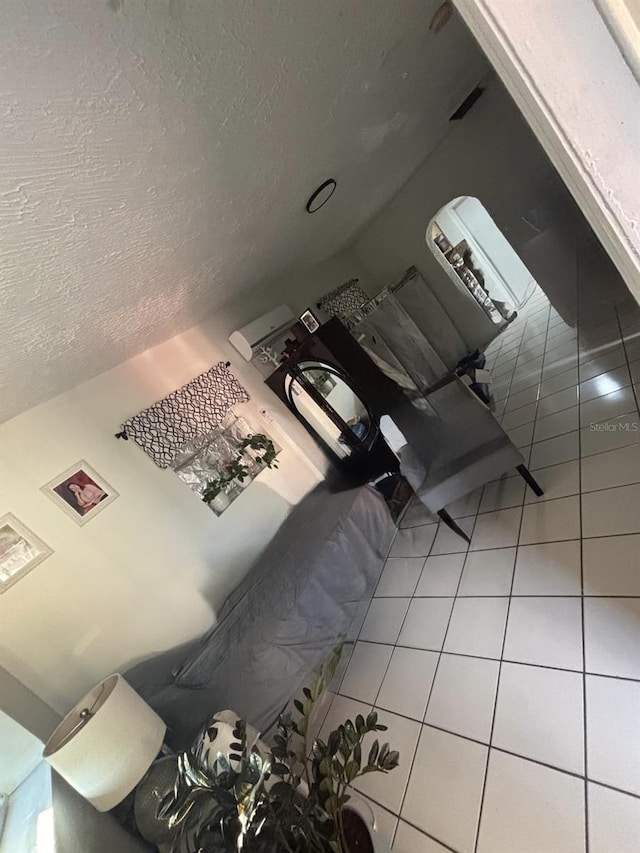 living room featuring tile patterned floors and a textured ceiling