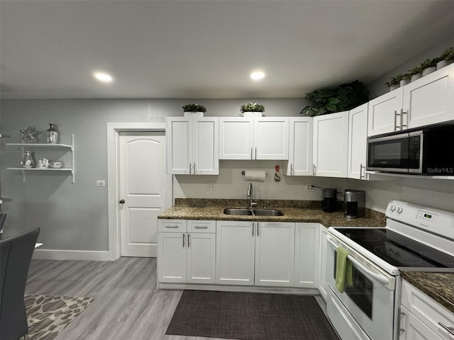 3565 NW 81st Ter, Miami, FL 33147 - kitchen with white electric stove, dark stone counters, stainless steel microwave, white cabinetry, and a sink