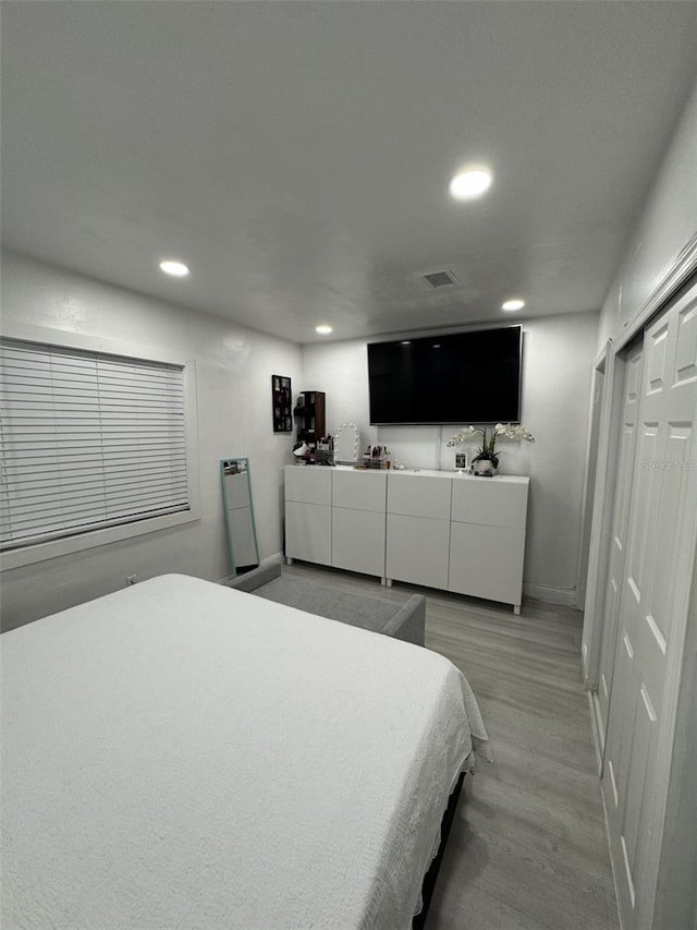 3565 NW 81st Ter, Miami, FL 33147 - bedroom featuring light wood finished floors, recessed lighting, a closet, visible vents, and baseboards