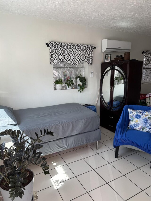 3565 NW 81st Ter, Miami, FL 33147 - bedroom with light tile patterned floors, a textured ceiling, and an AC wall unit