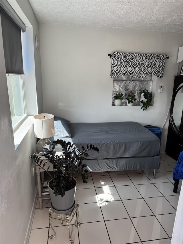 3565 NW 81st Ter, Miami, FL 33147 - tiled bedroom featuring a textured ceiling
