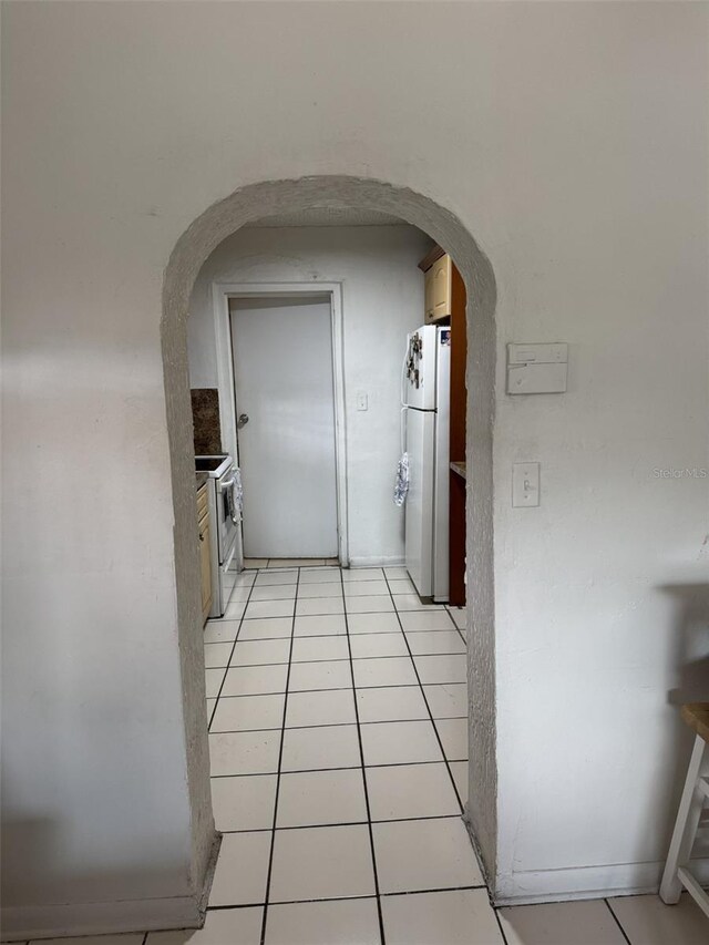 3565 NW 81st Ter, Miami, FL 33147 - kitchen featuring arched walkways, white appliances, and light tile patterned floors