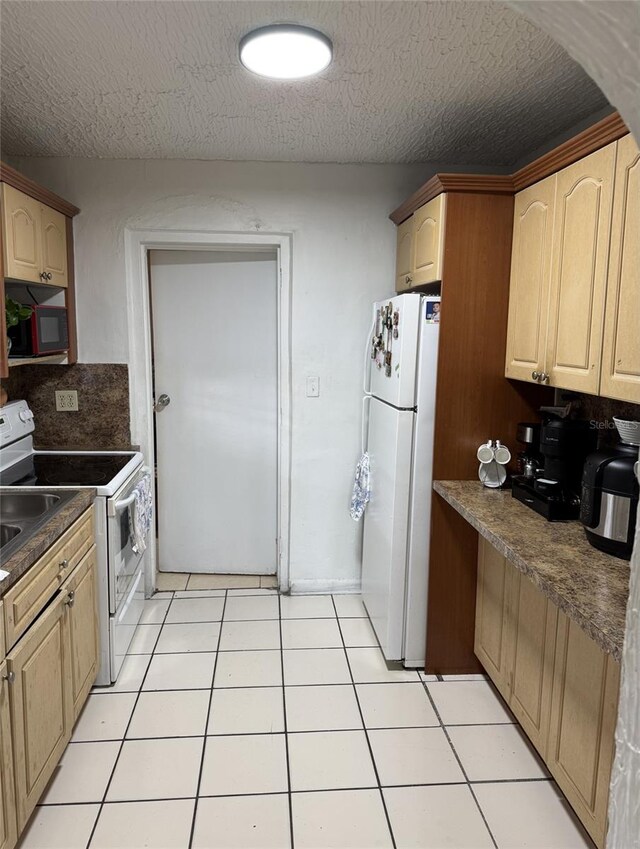 3565 NW 81st Ter, Miami, FL 33147 - kitchen featuring light tile patterned floors, backsplash, light brown cabinets, a textured ceiling, and white appliances