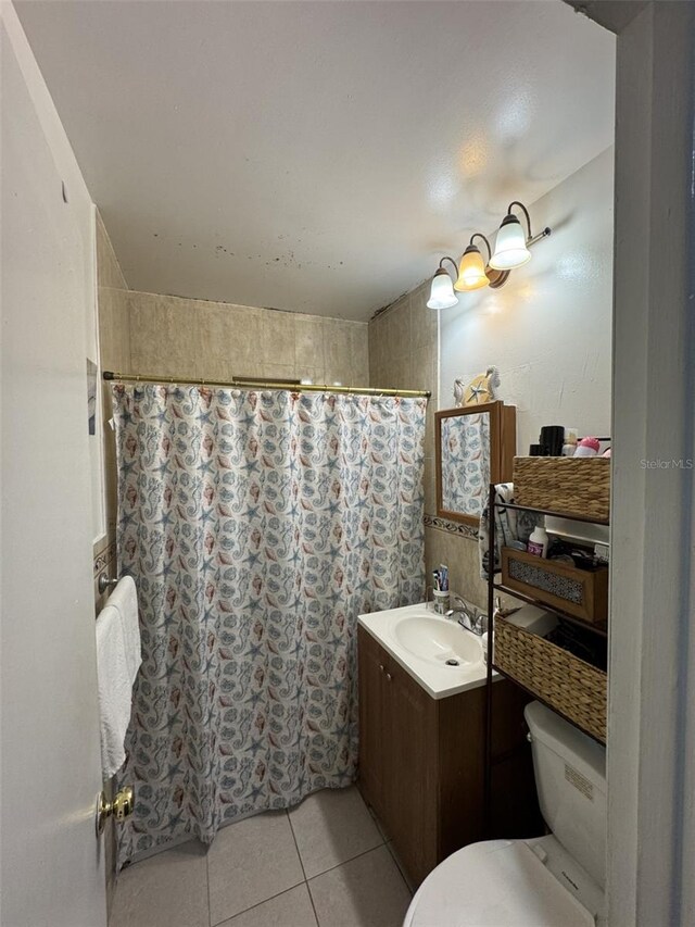 3565 NW 81st Ter, Miami, FL 33147 - bathroom featuring tile patterned flooring, a shower with shower curtain, vanity, and toilet