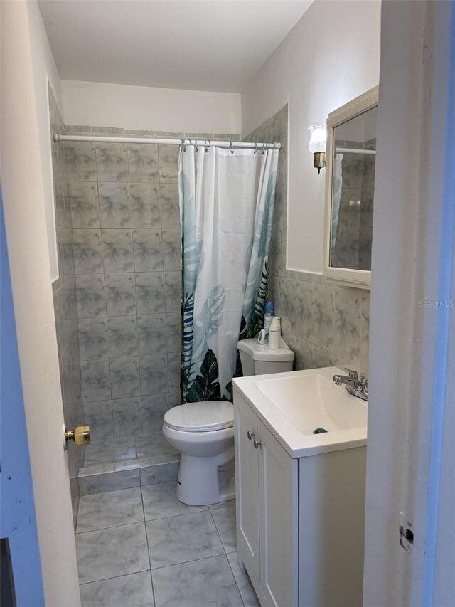 3565 NW 81st Ter, Miami, FL 33147 - bathroom with toilet, tiled shower, tile walls, and vanity