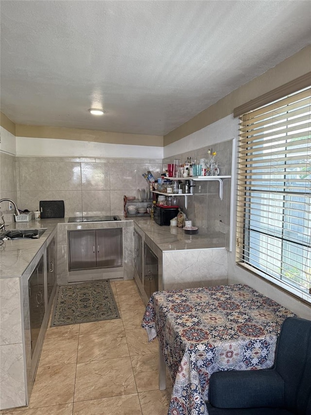 3565 NW 81st Ter, Miami, FL 33147 - kitchen with a textured ceiling, light countertops, and a sink