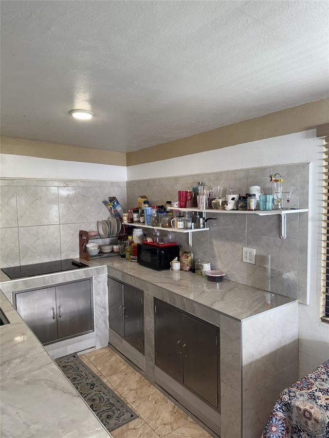 3565 NW 81st Ter, Miami, FL 33147 - kitchen featuring stone counters, a textured ceiling, black electric stovetop, and open shelves