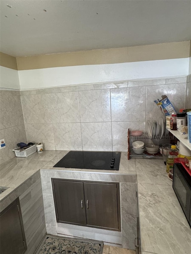 3565 NW 81st Ter, Miami, FL 33147 - kitchen featuring black appliances, light countertops, and decorative backsplash