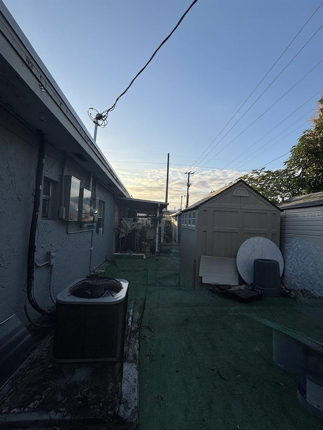 3565 NW 81st Ter, Miami, FL 33147 - view of yard featuring a shed, cooling unit, and an outdoor structure