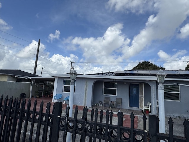 3565 NW 81st Ter, Miami, FL 33147 - view of front facade with a fenced front yard, a porch, and stucco siding
