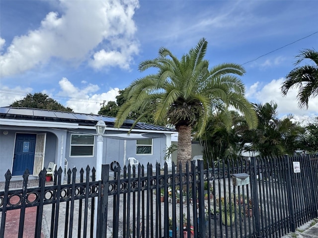 view of gate with a fenced front yard