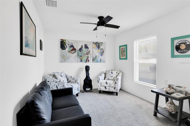 sitting room with carpet flooring and ceiling fan