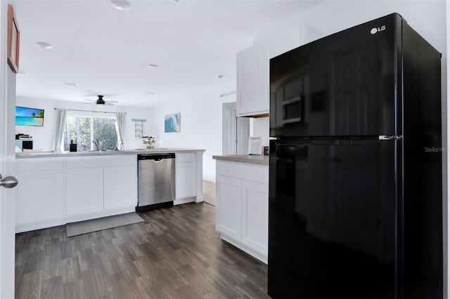 kitchen featuring black fridge, stainless steel dishwasher, ceiling fan, dark hardwood / wood-style flooring, and white cabinetry