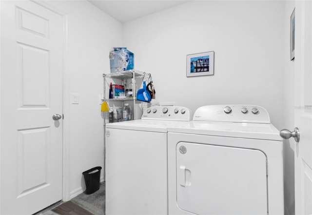 laundry area with hardwood / wood-style floors and washer and clothes dryer