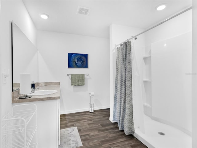 bathroom featuring hardwood / wood-style floors, vanity, and a shower with curtain