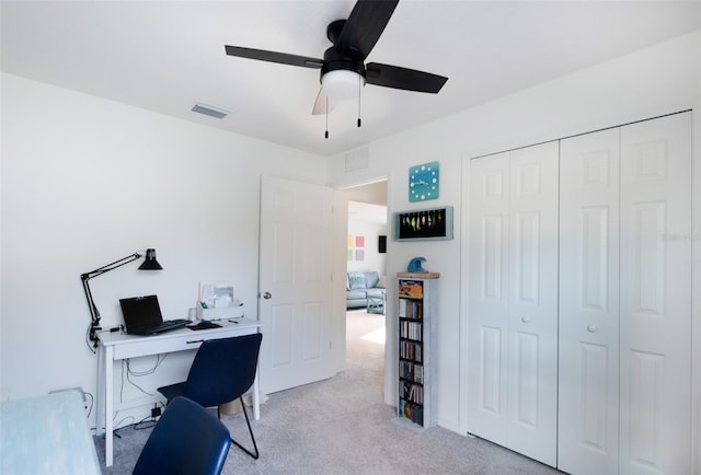 office space with light colored carpet and ceiling fan