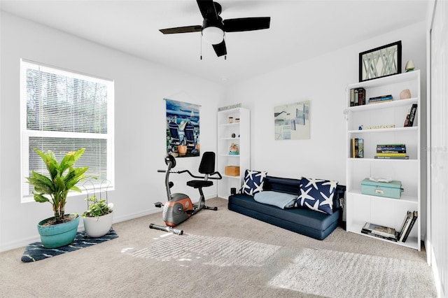 workout room featuring ceiling fan and carpet floors