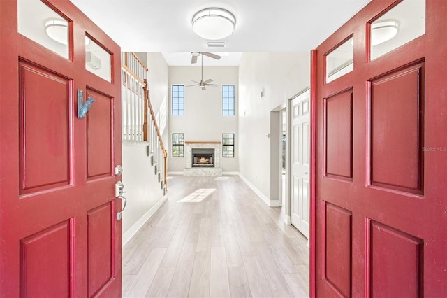 foyer entrance featuring ceiling fan and light wood-type flooring