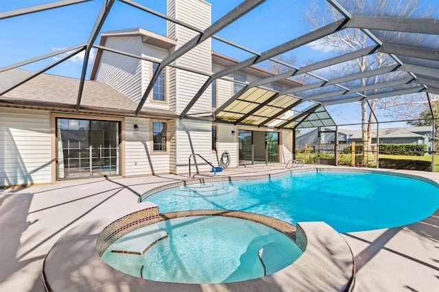 view of swimming pool with a lanai, a patio, and an in ground hot tub