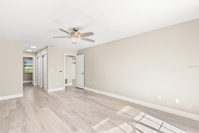 empty room featuring ceiling fan and light hardwood / wood-style floors