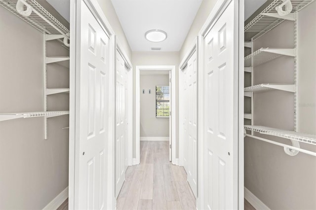 hallway with light hardwood / wood-style flooring