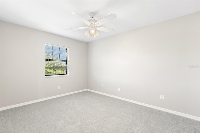 spare room with carpet flooring and ceiling fan