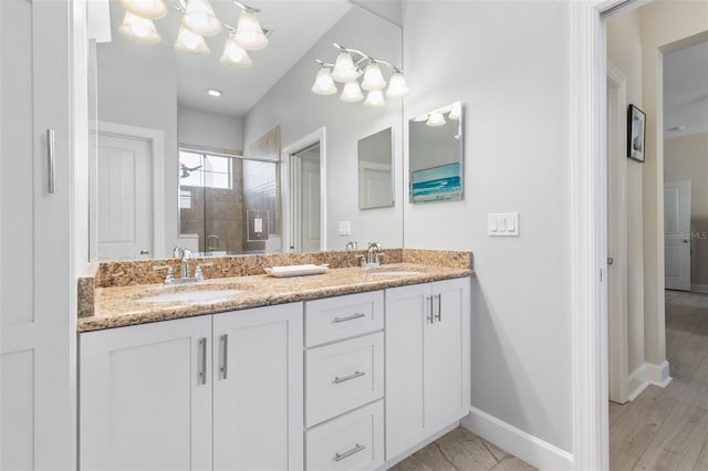 bathroom featuring vanity and a shower with door