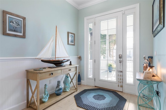 entryway featuring plenty of natural light and ornamental molding