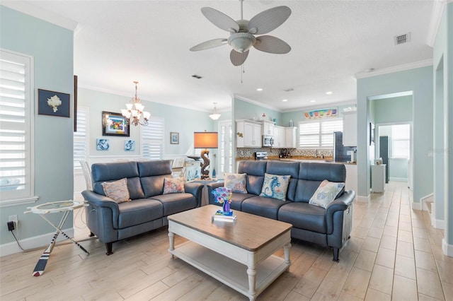 living room featuring light wood-type flooring, ceiling fan with notable chandelier, and crown molding