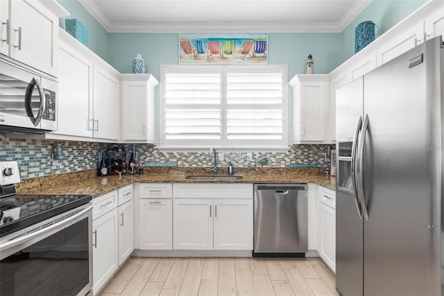 kitchen featuring white cabinets, dark stone countertops, sink, and appliances with stainless steel finishes