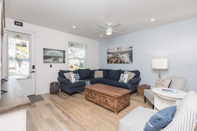 living room featuring ceiling fan and light hardwood / wood-style flooring