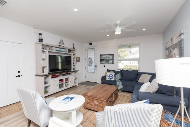 living room with light hardwood / wood-style floors and ceiling fan