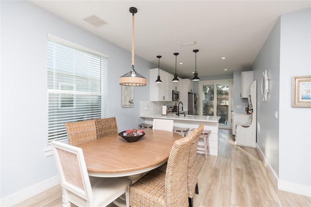 dining room featuring light hardwood / wood-style flooring and sink